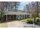 Beautiful exterior view of this home featuring a screened in porch, lovely paint colors, and mature landscaping at 621 Spruce Dr, Stone Mountain, GA 30083