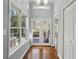 Hallway with hardwood floors, a view outside, and a storage closet at 621 Spruce Dr, Stone Mountain, GA 30083
