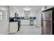 Bright, updated kitchen featuring white cabinets, stainless steel appliances, and a beautiful backsplash at 621 Spruce Dr, Stone Mountain, GA 30083