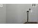 Appliance hookups and outlets on a neutral wall in a laundry room space with brown tiled floors at 621 Spruce Dr, Stone Mountain, GA 30083