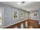 Fresh living room featuring gleaming hardwood floors, natural light, and modern lighting at 621 Spruce Dr, Stone Mountain, GA 30083