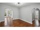 Bright living room featuring beautiful hardwood floors, archways, and fresh paint at 621 Spruce Dr, Stone Mountain, GA 30083