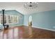 Spacious living room with many windows, hardwood floors, and light blue walls at 621 Spruce Dr, Stone Mountain, GA 30083