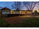 Expansive backyard view showcasing the deck, stone fireplace, and well-maintained lawn at 1199 Murray Sw Cir, Marietta, GA 30064