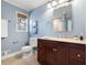 Charming bathroom featuring a wood vanity, granite countertop, and blue walls at 1199 Murray Sw Cir, Marietta, GA 30064