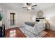 Inviting bedroom with hardwood floors, accent wall, and a door leading to a sunroom at 1199 Murray Sw Cir, Marietta, GA 30064