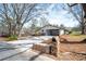 Long driveway leading to a garage featuring a stone mailbox, with lots of mature trees in the yard at 1199 Murray Sw Cir, Marietta, GA 30064