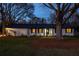 Exterior of the attractive white brick home featuring dark trim, decorative lattice, and manicured front lawn at 1199 Murray Sw Cir, Marietta, GA 30064