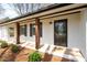 Home's inviting front porch with dark trim and glass door at 1199 Murray Sw Cir, Marietta, GA 30064