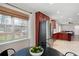 Open kitchen with stainless steel refrigerator, cherry cabinets, and a view of the backyard through a large window at 1199 Murray Sw Cir, Marietta, GA 30064