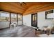 Bright sunroom with a wood ceiling, brick accent wall, and sliding glass windows at 1199 Murray Sw Cir, Marietta, GA 30064
