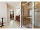 Bathroom with stone tiled shower and glass door, tile floors and a vanity with wooden drawers at 1249 Austin Thomas Dr, Dacula, GA 30019