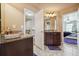 Bathroom with granite countertops on the vanities, tile floors and a view into the bedroom at 1249 Austin Thomas Dr, Dacula, GA 30019
