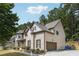 Two-story home featuring a side-entry garage, brick accents, and beautifully manicured landscaping at 1249 Austin Thomas Dr, Dacula, GA 30019