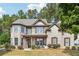 Charming brick two-story home with a welcoming front porch and professionally landscaped front yard at 1249 Austin Thomas Dr, Dacula, GA 30019