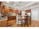 Kitchen featuring a center island, wooden cabinetry, hardwood floors, and modern appliances at 1249 Austin Thomas Dr, Dacula, GA 30019