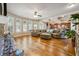 Spacious living room with hardwood floors, fireplace, and large windows offering ample sunlight at 1249 Austin Thomas Dr, Dacula, GA 30019