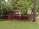 The backyard features a spacious deck, perfect for outdoor relaxation and entertaining, nestled amongst mature trees for privacy at 2380 Strathmore Dr, Atlanta, GA 30324