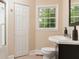 Clean bathroom with a single vanity, tiled floor, and white bi-fold door to the shower at 2380 Strathmore Dr, Atlanta, GA 30324