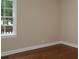 Well-lit bedroom with hardwood floors, neutral wall color, and a view to the backyard at 2380 Strathmore Dr, Atlanta, GA 30324