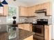 Well-lit kitchen with stainless steel appliances, granite countertops, and wooden cabinets at 2380 Strathmore Dr, Atlanta, GA 30324