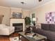Cozy living room features a fireplace with white mantel, hardwood floors, and neutral paint at 2380 Strathmore Dr, Atlanta, GA 30324