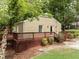 Back exterior view featuring a cozy home, wooden deck, and landscaped backyard at 2380 Strathmore Dr, Atlanta, GA 30324