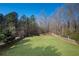 Large grassy backyard featuring a wooden fence and mature trees at 274 Sleepy Hollow Rd, Powder Springs, GA 30127