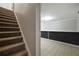 Basement stairs leading to a tiled room with black accent wall at 274 Sleepy Hollow Rd, Powder Springs, GA 30127