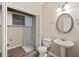 Cozy laundry/half bathroom with a pedestal sink, wood-look tile, and closet with storage space at 274 Sleepy Hollow Rd, Powder Springs, GA 30127