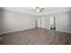 Large bedroom featuring hardwood floors, neutral paint, and ensuite bathroom access at 274 Sleepy Hollow Rd, Powder Springs, GA 30127