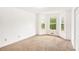 Bright bedroom featuring new carpeting and natural light from multiple windows at 100 Walnut Ct, Stockbridge, GA 30281