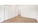 This carpeted bedroom includes a double door closet and entry to an adjacent room at 100 Walnut Ct, Stockbridge, GA 30281