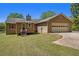 Charming home with a two-car garage and beautiful landscaping at 100 Walnut Ct, Stockbridge, GA 30281