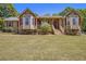 Inviting single-story home featuring a green lawn, stone accents, and a cozy front porch at 100 Walnut Ct, Stockbridge, GA 30281