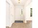 Bright foyer with a white front door, neutral carpet, and a blue patterned rug at 100 Walnut Ct, Stockbridge, GA 30281