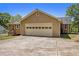 Attached two-car garage with multi-paneled door, spacious driveway, and manicured lawn at 100 Walnut Ct, Stockbridge, GA 30281
