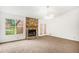 Spacious living room featuring a stone fireplace, neutral carpet and a ceiling fan at 100 Walnut Ct, Stockbridge, GA 30281