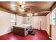 A serene spa room with a built-in hot tub, ceiling fan and natural light from the windows at 100 Walnut Ct, Stockbridge, GA 30281