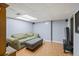 Basement living room with hardwood flooring, recessed lighting, and a comfortable seating area at 2050 Plantation Rd, Lawrenceville, GA 30044