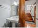 Charming half bathroom with a pedestal sink and hardwood floors at 2050 Plantation Rd, Lawrenceville, GA 30044