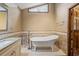 Luxurious bathroom showcasing a clawfoot tub, vanity, and unique window at 2050 Plantation Rd, Lawrenceville, GA 30044