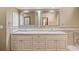 Bright bathroom featuring double vanity with granite countertop, decorative backsplash and large mirrors at 2050 Plantation Rd, Lawrenceville, GA 30044