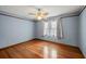Bedroom with a ceiling fan, hardwood floors, and curtains at 2050 Plantation Rd, Lawrenceville, GA 30044