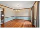 Traditional dining room with hardwood floors, chandelier, and large windows for ample natural light at 2050 Plantation Rd, Lawrenceville, GA 30044