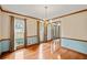 Bright dining room with hardwood floors, chandelier, and windows with views to the home's entry at 2050 Plantation Rd, Lawrenceville, GA 30044