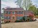 Charming brick two-story home with a beautiful front yard, decorative door surround and teal shutters at 2050 Plantation Rd, Lawrenceville, GA 30044
