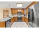 Well-equipped kitchen featuring stainless steel appliances, granite countertops, and tile flooring at 2050 Plantation Rd, Lawrenceville, GA 30044
