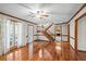 Open living room with hardwood floors, staircase, and plenty of natural light at 2050 Plantation Rd, Lawrenceville, GA 30044