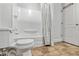 This bathroom shows a shower and tub combo with a patterned shower curtain, with a toilet and door nearby at 2224 Bridle Ct, Norcross, GA 30071